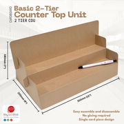 Cardboard 2-tier counter top unit with dimensions and a pen for scale on a white background.